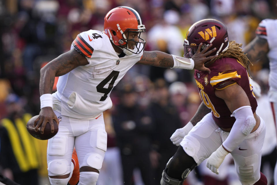 Cleveland Browns quarterback Deshaun Watson (4) gets away from Washington Commanders defensive end Chase Young (99) during the first half of an NFL football game, Sunday, Jan. 1, 2023, in Landover, Md. (AP Photo/Susan Walsh)