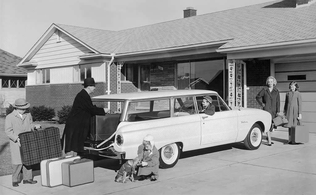 Family prepares to go on a trip in their 1960 Ford Falcon.