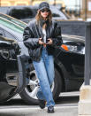 <p>Hailey Bieber wears an oversized coat, jeans and a cap while out in L.A. on Dec. 22.</p>