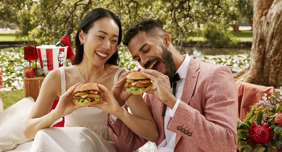 Couple at picnic eating KFC onion ring burgers
