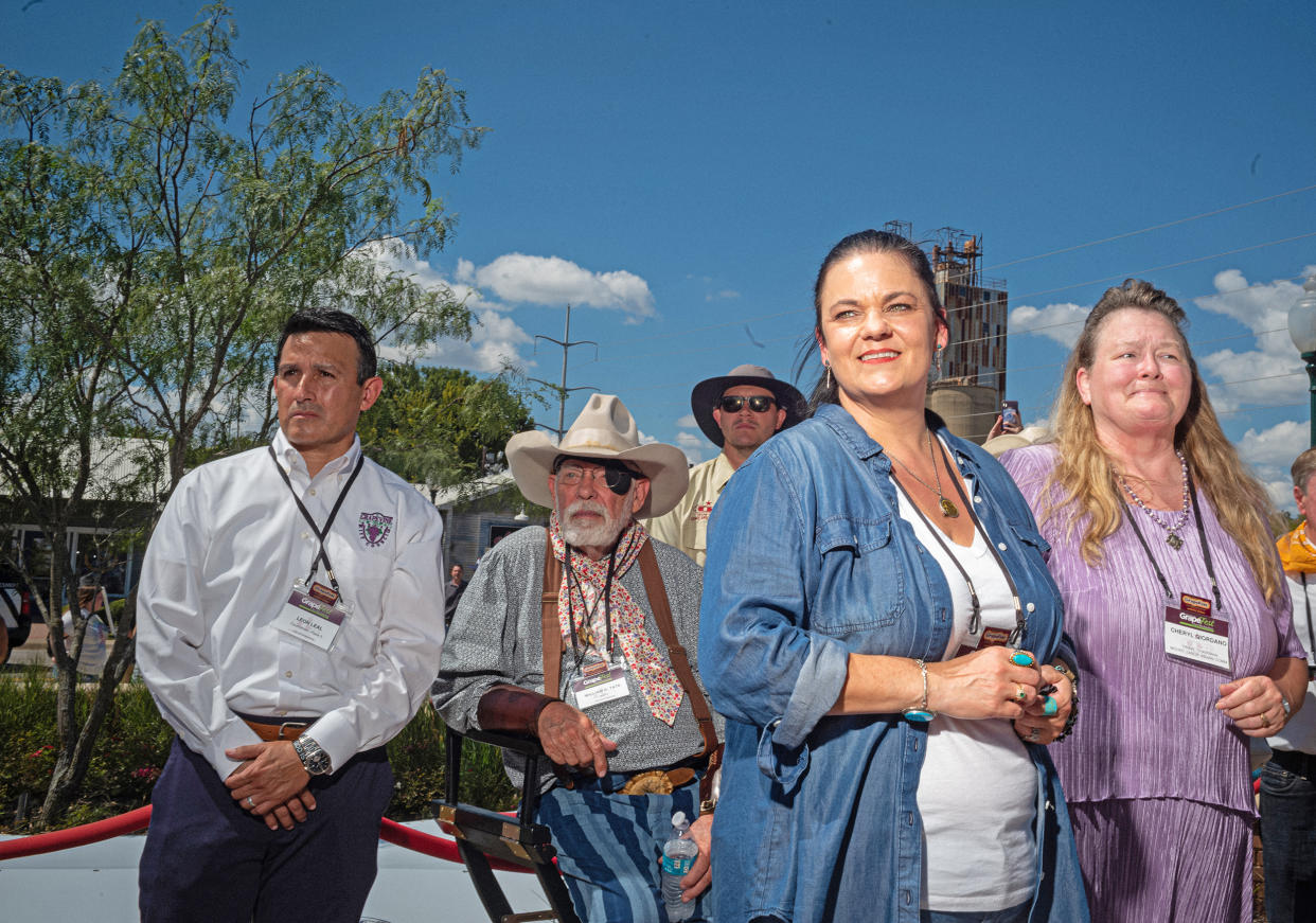 Members of the Mount Tabor Indian community, Tribal Chairman Cheryl Giordano, right, and Community Coordinator Amy Betts watch with Mayor Mayor William Tate, in cowboy hat, as the 