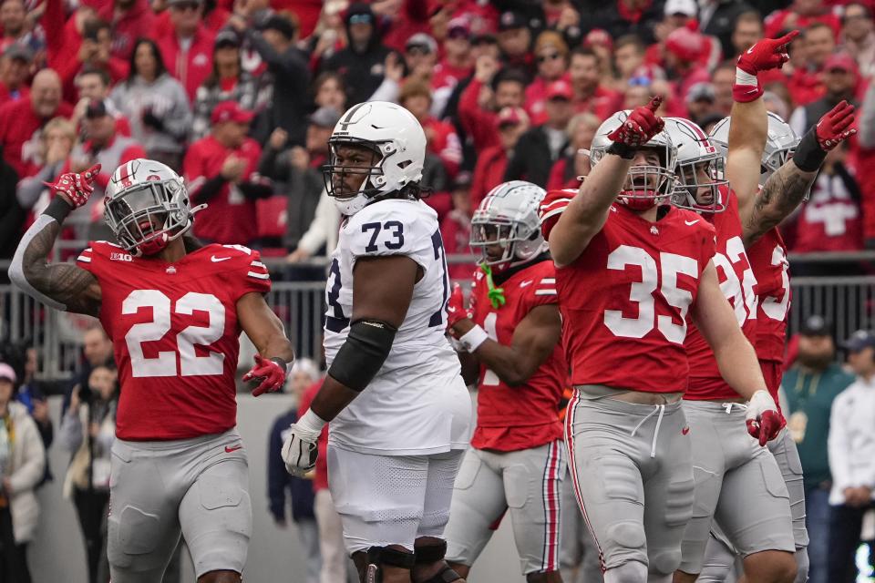 Oct 21, 2023; Columbus, Ohio, USA; Ohio State Buckeyes linebacker Steele Chambers (22), linebacker Tommy Eichenberg (35) and teammates celebrate a false start by Penn State Nittany Lions offensive lineman Caedan Wallace (73) during the NCAA football game at Ohio Stadium.