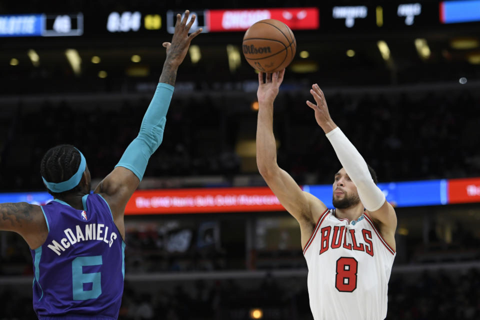 Chicago Bulls guard Zach LaVine (8) goes up for a shot against Charlotte Hornets forward Jalen McDaniels (6) during the first half of a NBA basketball game Monday, Nov. 29, 2021 in Chicago. (AP Photo/Paul Beaty)