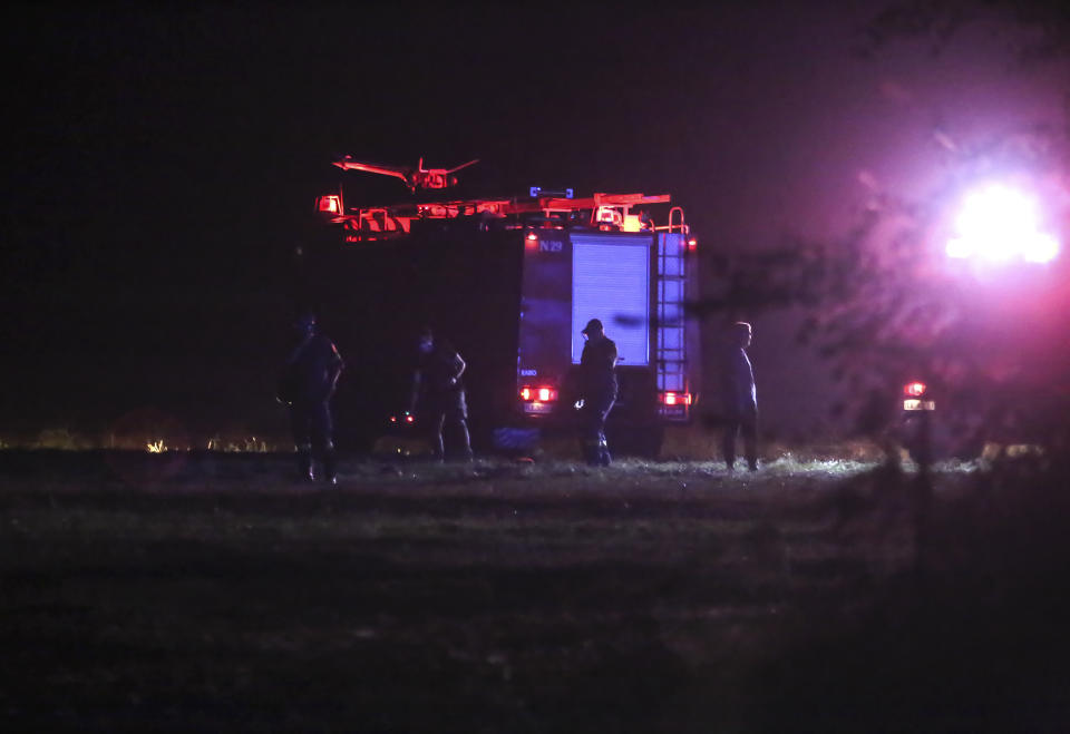 Firefighters are seen near the site of a plane crash, a few miles away from the city of Kavala, in northern Greece, Saturday, July 16, 2022. An Antonov cargo plane operated by a Ukraine-based air carrier crashed Saturday near the city of Kavala in northern Greece, authorities said. Greek Civil Aviation authorities say the flight was heading from Serbia to Jordan, but have not been able to confirm how many people were on board or what the plane's cargo was. (Ilias Kotsireas/InTime News via AP)