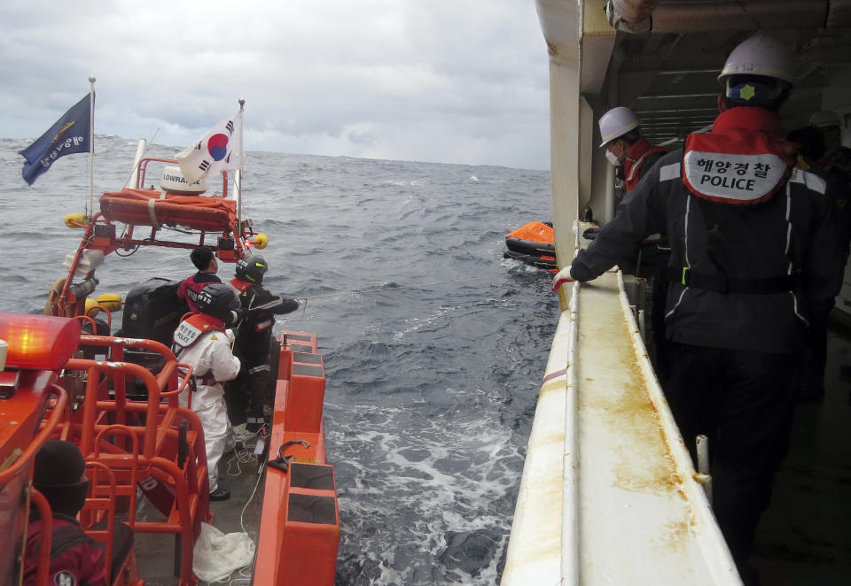 In this photo provided by the Korea Coast Guard, members of South Korea coast guard conduct a search operation in waters between South Korea and Japan, Wednesday, Jan. 25, 2023. South Korean and Japanese coast guards were searching for crew members of a cargo ship that sank early Wednesday in waters between South Korea and Japan, South Korean officials said Wednesday. (The Korea Coast Guard via AP)