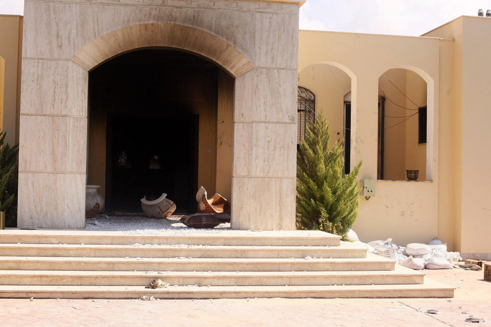 Soot and debris spills out of the U.S. Consulate after an attack by protesters in Benghazi, Libya, Wednesday, Sept. 12, 2012. (AP Photo/Ibrahim Alaguri)