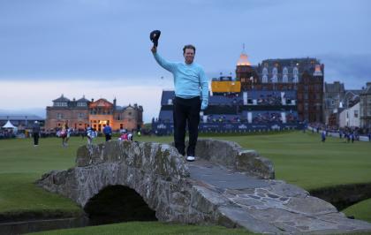 Tom Watson acknowledges the crowd as he poses on The Swilcan Bridge. (REUTERS)