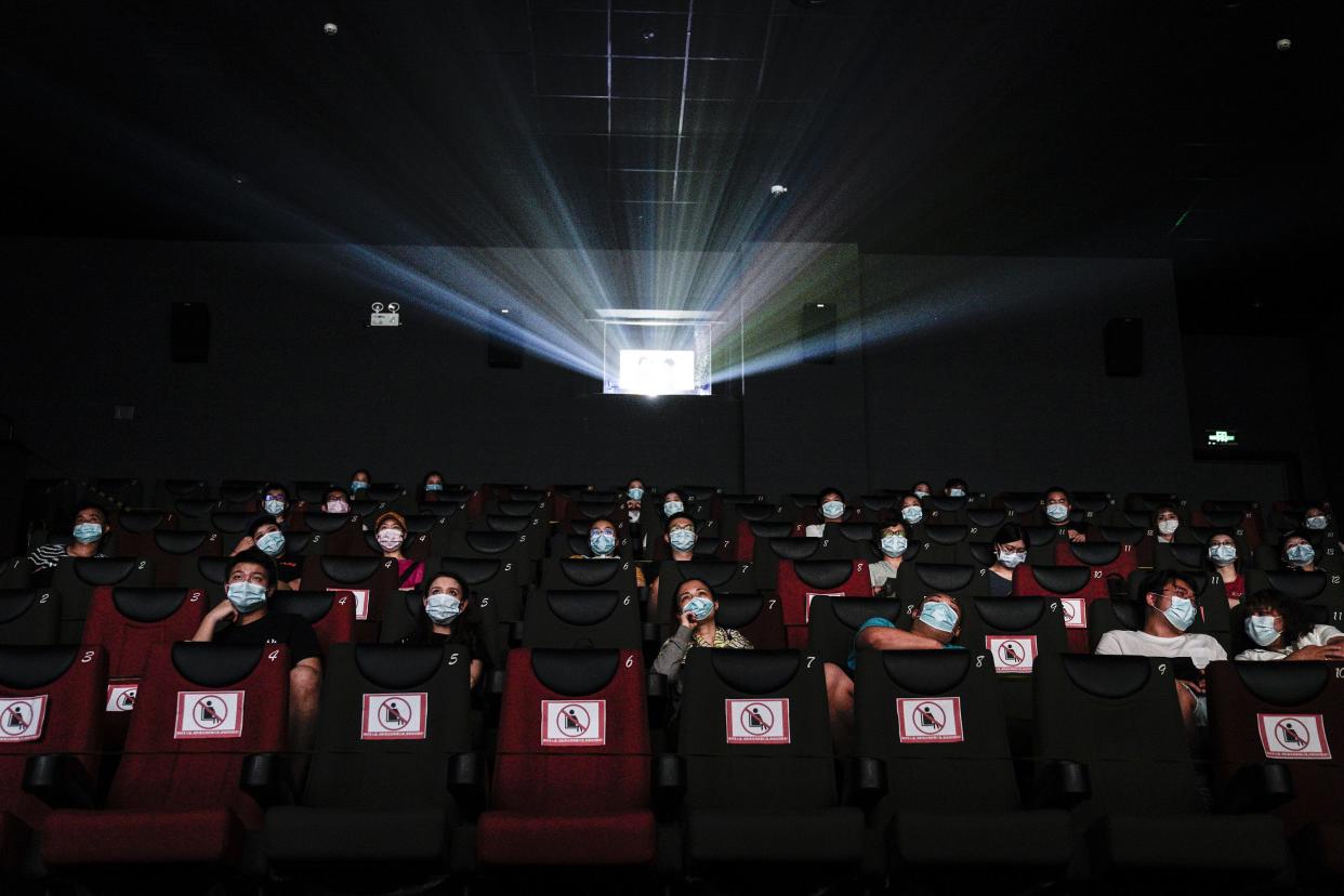 Residents watch a movie in a cinema on July 20, 2020, in Wuhan, Hubei Province, China. Taking various measures against COVID-19, cinemas in the city reopened in an orderly manner on Monday.