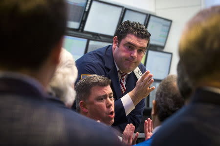 Traders, governors, and members of the New York Stock Exchange discuss what is happening following a halt in trading on the floor of the exchange in New York, July 8, 2015. REUTERS/Lucas Jackson