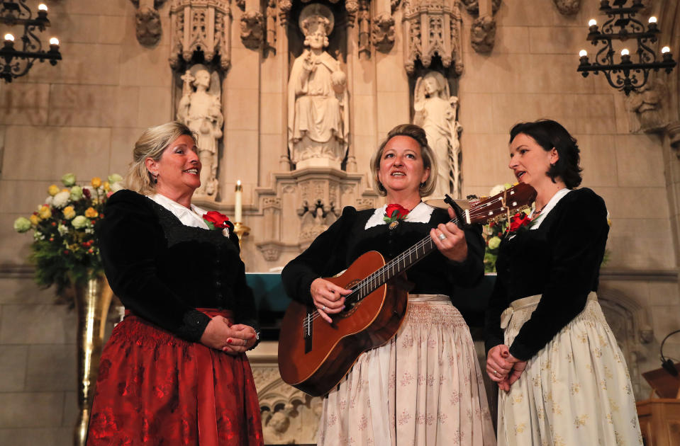 The Kroell Family Singers, Gerlinde, left, Elisabeth, center, and Christiane, sing Christmas Carols during a celebration of the song "Silent Night," at Trinity Church, Tuesday, Nov. 27, 2018, in New York. "Silent Night," one of the most famous songs of the Christmas season, is being celebrated as it approaches its 200th anniversary. Written and sung in Austria in December 1818, the song was first performed in the U.S. in 1839 at the Hamilton Memorial on the church's grounds by an Austrian family of traveling singers. (AP Photo/Julie Jacobson)