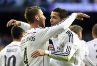 Real Madrid's Sergio Ramos (L) is congratulated by teammate Cristiano Ronaldo after scoring during the Spanish league match against Malaga in Madrid on April 18, 2015