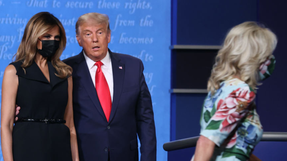 Melania and Donald Trump watch Dr Jill Biden cross the stage of an presidential debate to greet husband Joe