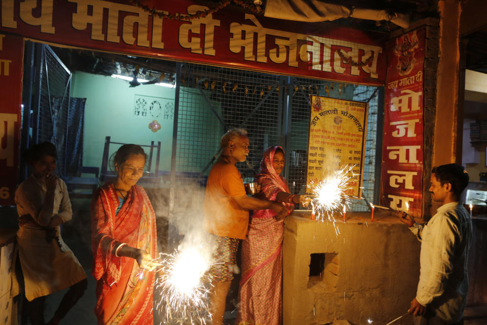 Residents light firecrackers to celebrate the verdict in a decades-old land title dispute between Muslims and Hindus, in Ayodhya, India , Saturday, Nov. 9, 2019. India's Supreme Court on Saturday ruled in favor of a Hindu temple on a disputed religious ground and ordered that alternative land be given to Muslims to build a mosque. The dispute over land ownership has been one of the country's most contentious issues. (AP Photo/Rajesh Kumar Singh)