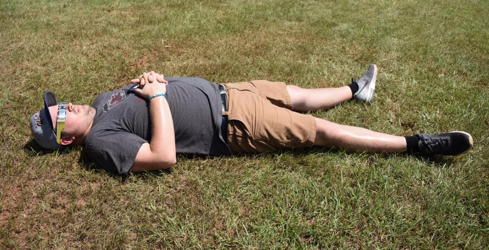 John Braun's son Tom of Ardsley, Pennsylvania, takes the ideal eclipse viewing position, including eclipse glasses, during the 2017 solar eclipse.