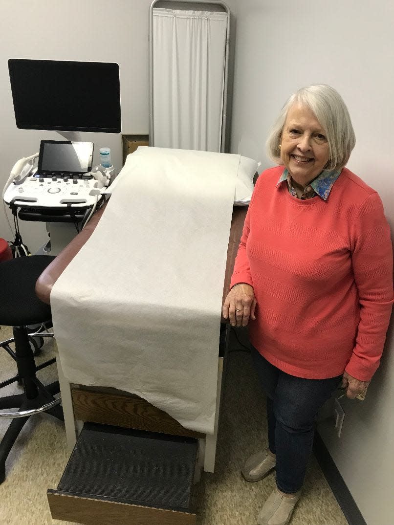 Margaret Horvath, executive director of Heartbeat of Monroe, stands by an ultrasound machine purchased by Monroe Council 1266, Knights of Columbus.