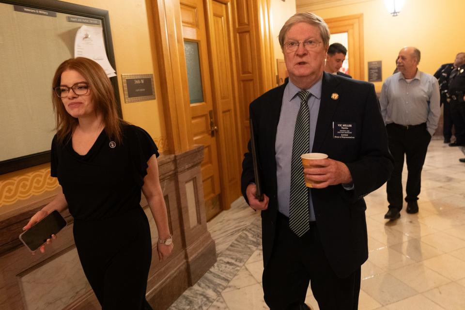 Rep. Vic Miller, D-Topeka, walks with spokesperson Alexis Simmons on the way to the House of Representative chambers Wednesday.