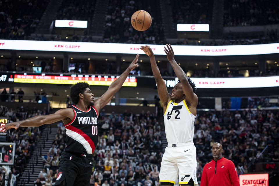 Utah Jazz guard Collin Sexton (2) shoots the ball past Portland Trail Blazers guard Scoot Henderson (00) during the second half of an NBA preseason basketball game Saturday, Oct. 14, 2023, in Salt Lake City. (AP Photo/Isaac Hale)