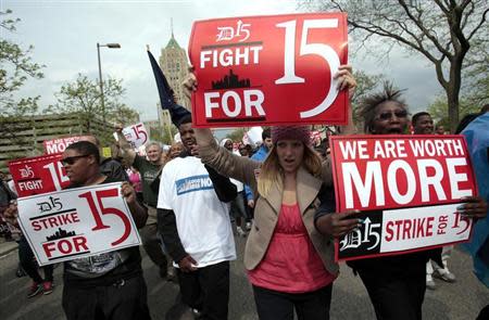 A group of workers and labor activists march down West Grand Boulevard as they demand a raise in the minimum wage for fast food workers in Detroit, Michigan May 10, 2013. REUTERS/Rebecca Cook