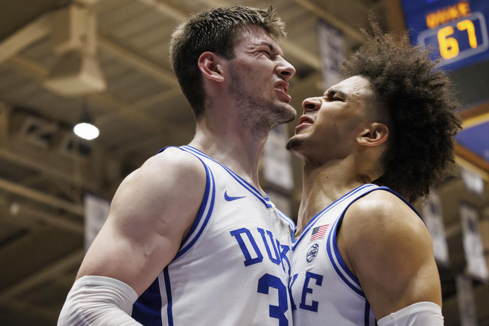 Duke's Kyle Filipowski, left, and Tyrese Proctor, right, celebrate after a play during the second half of an NCAA college basketball game against Clemson in Durham, N.C., Saturday, Jan. 27, 2024. (AP Photo/Ben McKeown)