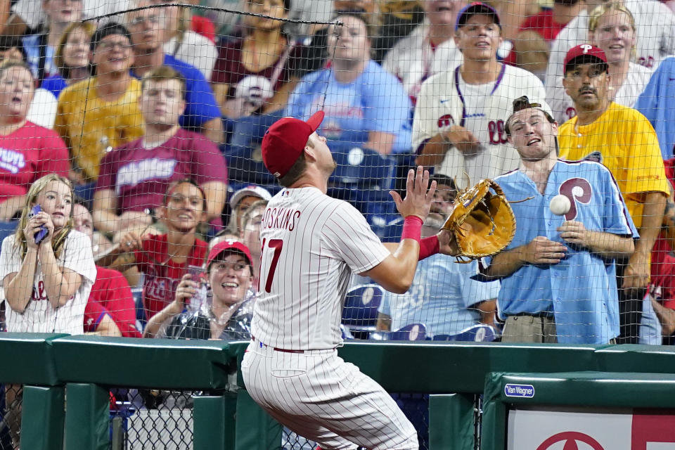 Philadelphia Phillies first baseman Rhys Hoskins cannot reach a foul ball by Cincinnati Reds' Donovan Solano during the fourth inning of a baseball game, Monday, Aug. 22, 2022, in Philadelphia. (AP Photo/Matt Slocum)