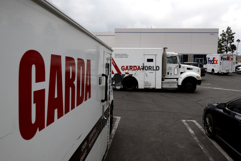 Armored trucks are parked outside the offices of GardaWorld in the Sylmar section of Los Angeles on Thursday, April 4, 2024. Thieves stole as much $30 million in an Easter Sunday burglary at a Los Angeles money storage facility in one of the largest cash heists in city history. (AP Photo/Richard Vogel)