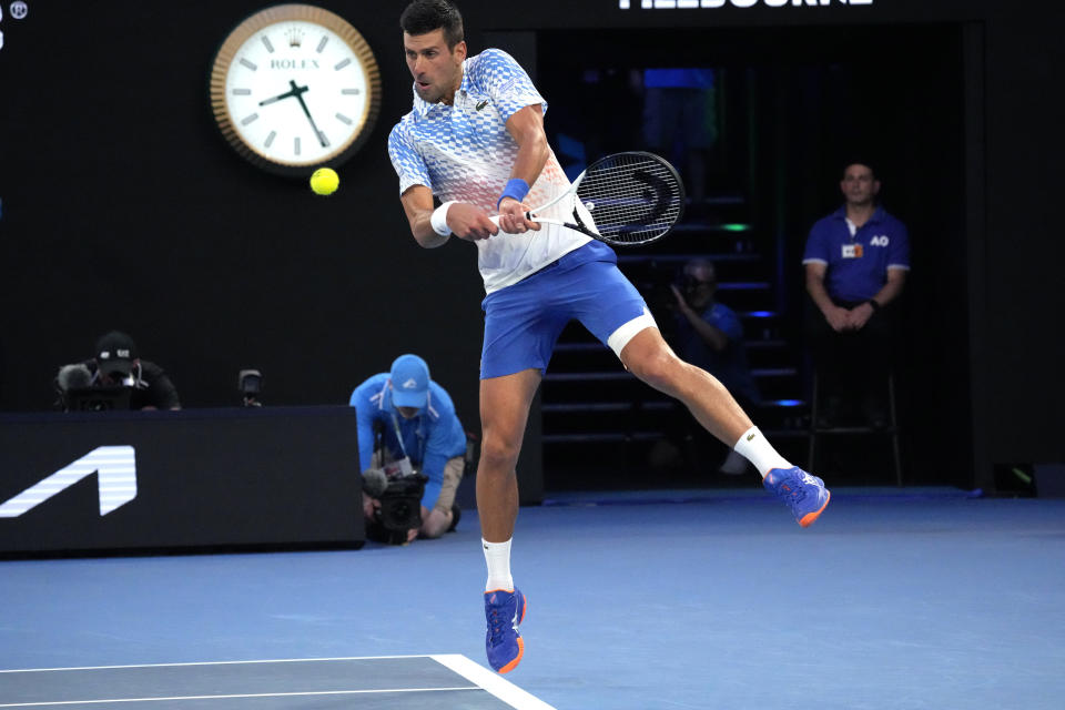 Novak Djokovic of Serbia plays a backhand return to Tommy Paul of the U.S. during their semifinal at the Australian Open tennis championship in Melbourne, Australia, Friday, Jan. 27, 2023. (AP Photo/Aaron Favila)