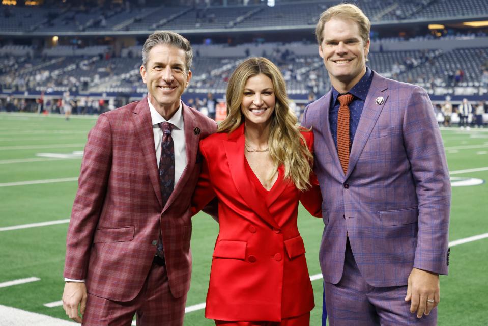 FOX broadcasters, from left to right, Kevin Burkhardt, Erin Andrews and Greg Olsen pose on the sideline before an NFL football game between the New York Giants and Dallas Cowboys Thursday, Nov. 24, 2022, in Arlington, Texas. (AP Photo/Michael Ainsworth)