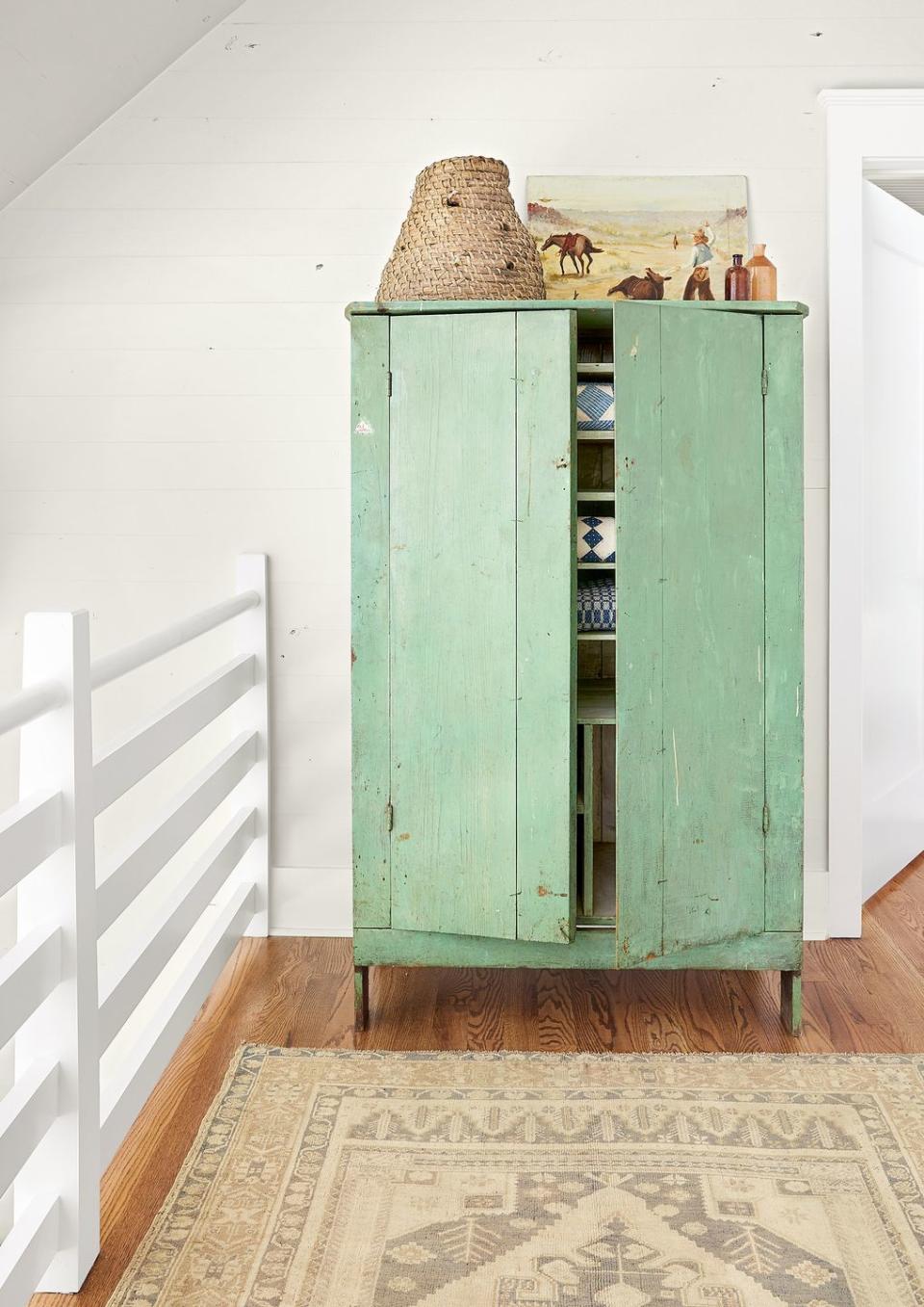 green chippy armoire in white room