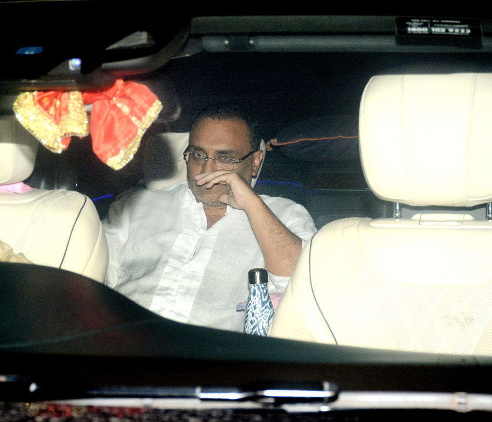 Aditya Chopra pensively looks on from the car.