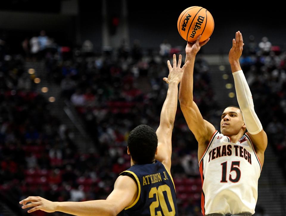 Texas Tech's Kevin McCullar (15), right, shoots the ball against Notre Dame's Paul Atkionson, Jr. (20), left, in the NCAA tournament's second round game, Sunday, March 20, 2022, at Viejas Arena in San Diego, California.