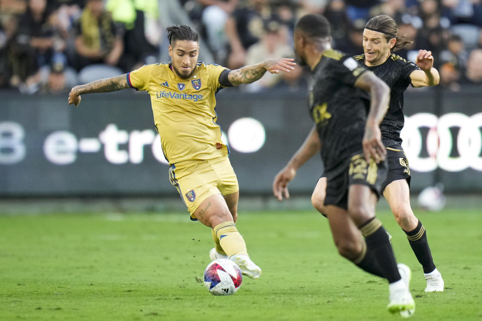 Real Salt Lake forward Cristian Arango, left, dribbles under pressure from Los Angeles FC midfielder Ilie S·nchez during the first half of an MLS soccer match Sunday, Oct. 1, 2023, in Los Angeles. (AP Photo/Jae C. Hong)