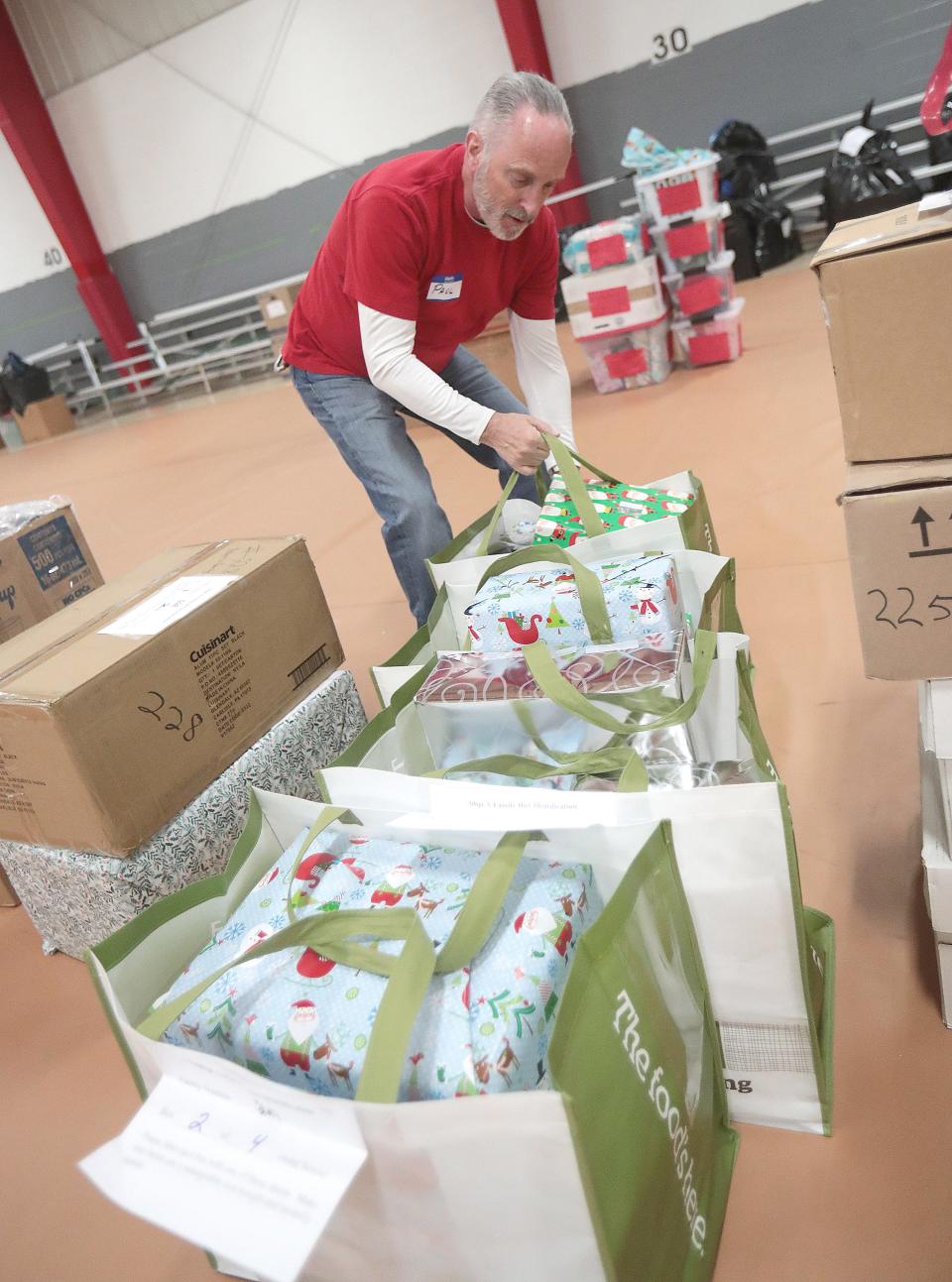Paul Johanning, a gift intake volunteer, separates gifts at the Southeast Community Center in Canton.