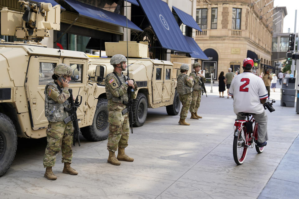 Minnesota National Guard soldiers stand watch along the famous Nicollet Mall, Thursday, Aug. 27, 2020, in downtown Minneapolis, following vandalism and looting unrest that broke out Wednesday night following what authorities said was misinformation about the suicide of a Black homicide suspect. (AP Photo/Jim Mone)