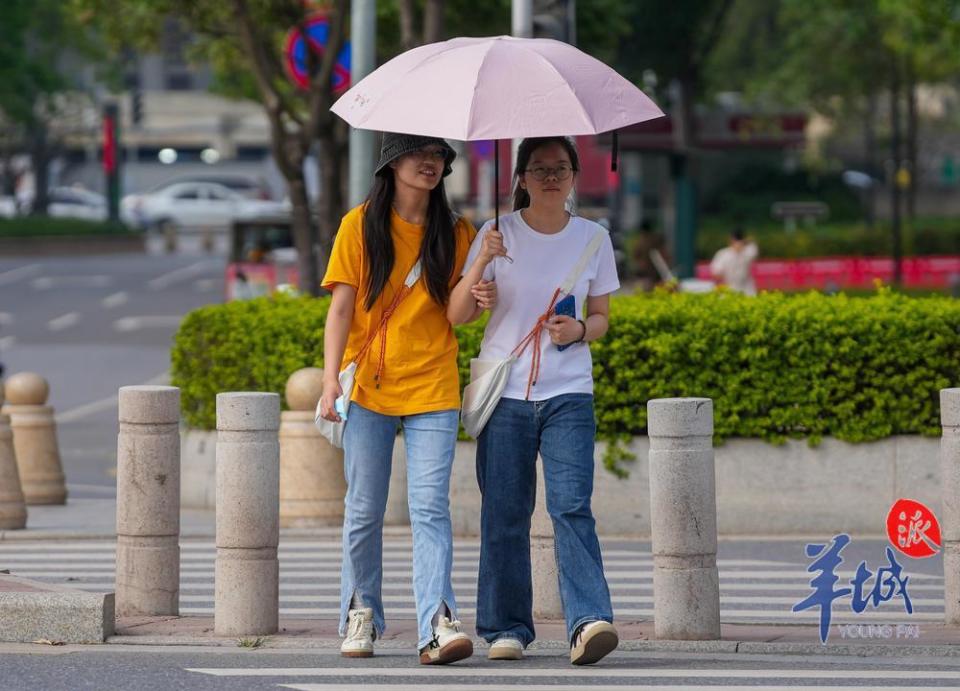 <strong>3月25日，已經入夏的廣州，民眾穿短袖撐傘遮陽上街。（圖／翻攝《羊城派》）</strong>