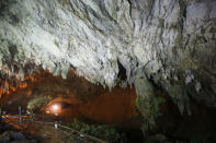 <p>A Thai rescuer walks out of the cave complex on June 29, 2018, where it’s believed that 12 soccer team members and their coach went missing, in Mae Sai, Chiang Rai Province, in northern Thailand. Rescuers punched a hole into the side of a mountain Thursday in a desperate attempt to drain rising water. (Photo: Sakchai Lalit/AP) </p>