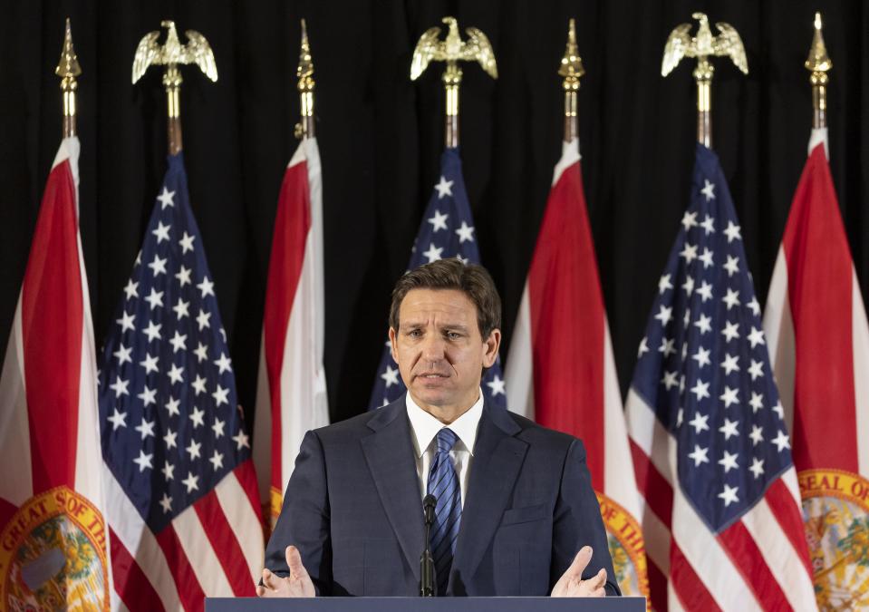 Florida Governor Ron DeSantis answers questions from the media during a press conference at Christopher Columbus High School on Monday, March 27, 2023, in Miami, Fla. The press conference was held to announce DeSantis's signing of a private school voucher expansion, HB1, which allows more Florida school children become eligible for taxpayer-funded school vouchers.(Matias J. Ocner/Miami Herald via AP)