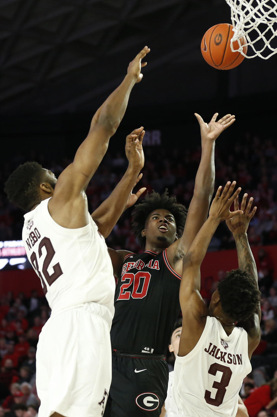 Georgia's Rayshaun Hammonds (20) takes a shot while being defended by Texas A&M forward Josh Nebo (32) and Texas A&M guard Quenton Jackson (3) during an NCAA basketball game in Athens, Ga., on Saturday, Feb. 1, 2020. (Joshua L. Jones/Athens Banner-Herald via AP)