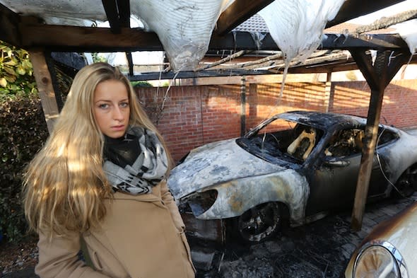 BNPS.co.uk (01202 558833) Pic: RichardCrease/BNPS  ***Please use full byline***  Eloise Towning with her parents' destroyed cars.  Crime novelist Andrew Towning fears life is imitating art after an arsonist torched his Porsche car in a copycat attack of one of his storylines.  The best-selling author believes the offender was inspired to set fire to his £18,000 Porsche Carrera after reading one of his Jake Dillon crime-thriller novels.  The blaze caused a small explosion and sent flames 10ft into the air.  In his 2010 book 'Shroud of Concealment', the lead character has his own Porsche 911 car blown up in the street after being targeted by a underworld crime gang.  Now Mr Towning fears he has been singled out by one of his readers following the attack at his home in Merley, near Wimborne, Dorset.