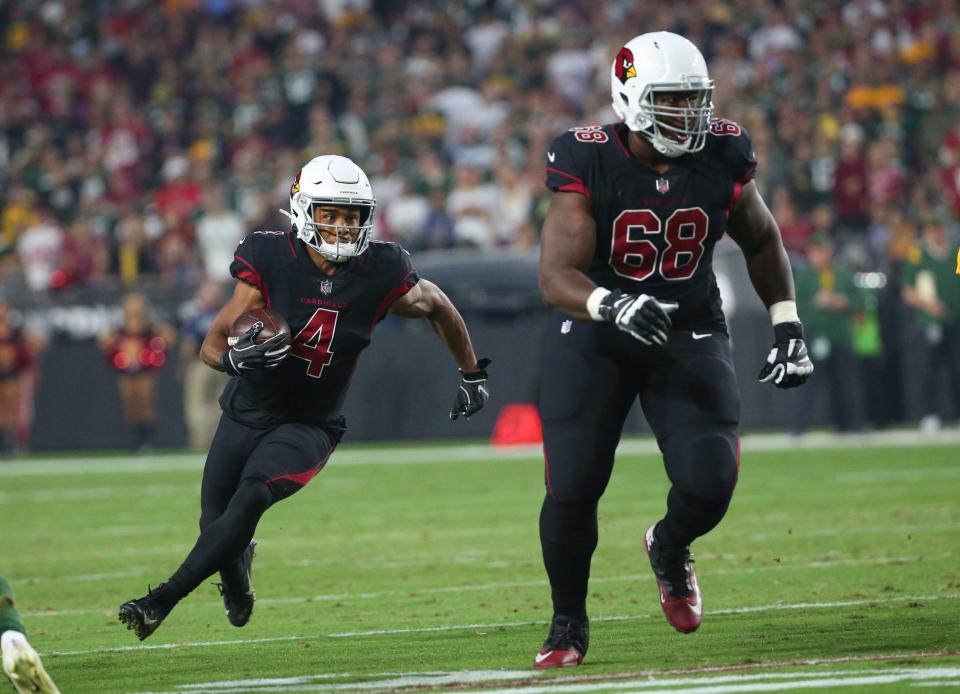 Arizona Cardinals wide receiver Rondale Moore (4) runs behind offensive tackle Kelvin Beachum (68) against the Green Bay Packers during the first quarter in Glendale, Ariz. Oct. 28, 2021.