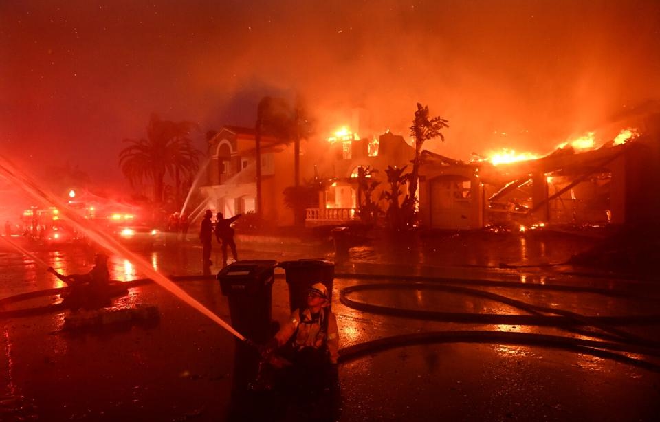 Home burn as hoses spray water in different directions