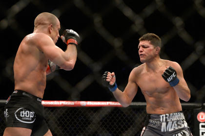 Nick Diaz (R) taunts Georges St.Pierre during their UFC 158 fight. (USAT)