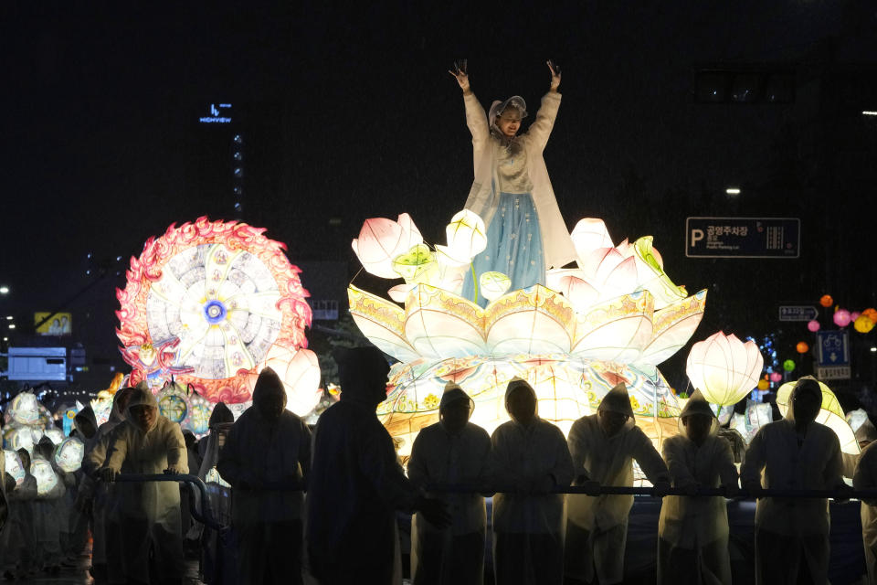 A woman waves from a lantern float during the Lotus Lantern Festival ahead of the upcoming birthday of Buddha on May 15, on a street in Seoul, South Korea, Saturday, May 11, 2024. (AP Photo/Ahn Young-joon)