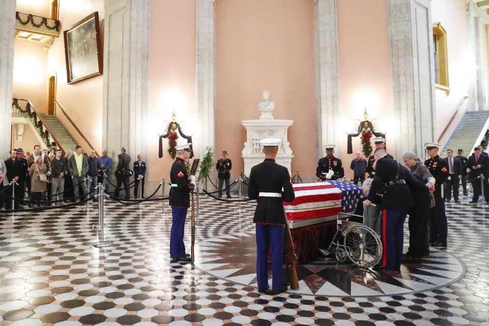 Annie Glenn is brought to the side of her husband John Glenn's casket as he lies in honor, Friday, Dec. 16, 2016, in Columbus, Ohio. Glenn's home state and the nation began saying goodbye to the famed astronaut who died last week at the age of 95. (AP Photo/John Minchillo)