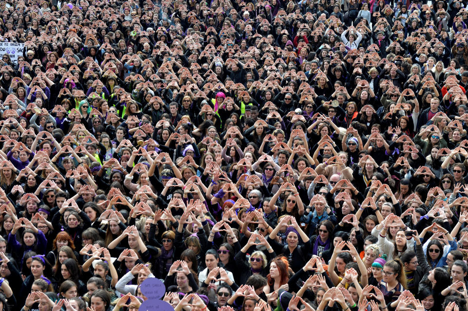 Protesters form triangles with their hands during a demonstration for women's rights.