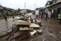 Army soldiers help residents remove mud from damaged houses following heavy rains in Cheorwon, South Korea, Thursday, Aug. 6, 2020. Torrential rains continuously pounded South Korea on Thursday, prompting authorities to close parts of highways and issue a rare flood alert near a key river bridge in Seoul. (AP Photo/Ahn Young-joon)