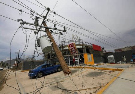 A downed power line is pictured next to a store in San Jose del Cabo, after Hurricane Odile hit Baja California September 19, 2014. REUTERS/Henry Romero