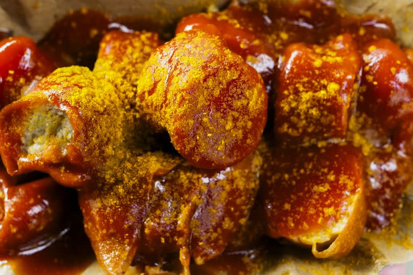 Currywurst, Germany's sausage with curry sauce, served on a cardboard at Konnopke's Imbiß, a fast-food joint at Berlin's Eberswalder Straße U-Bahn station