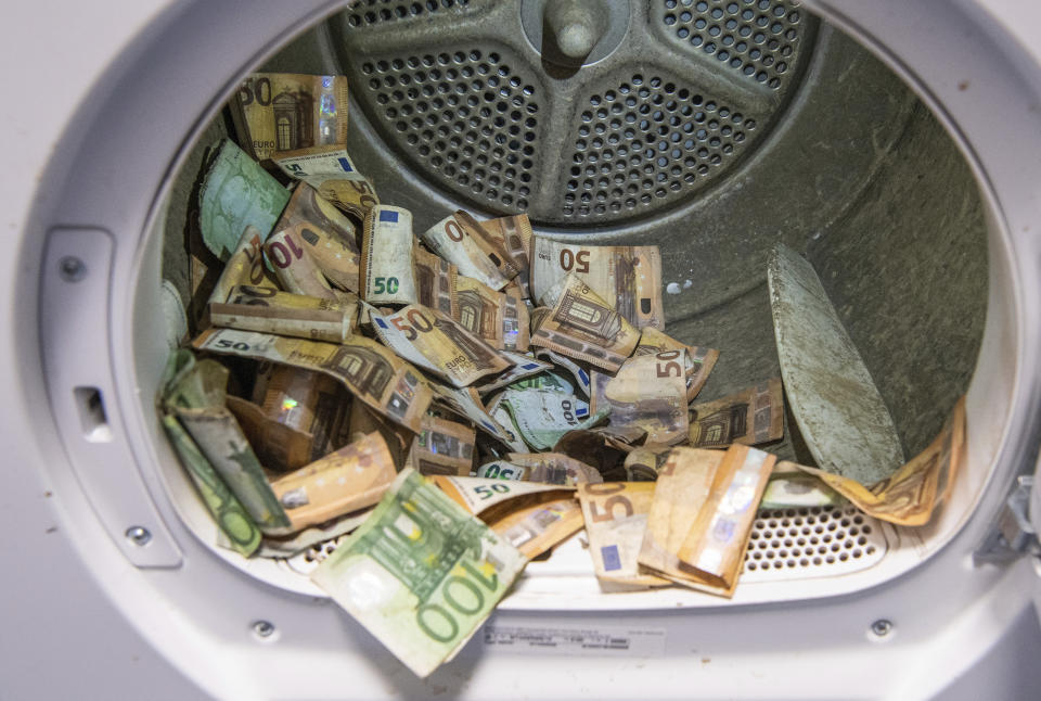 Euro banknotes damaged in the flood disaster are dried in a standard tumble dryer at the Bundesbank in Mainz, Germany, Wednesday, Sept. 1, 2021. Germany’s central bank says it has been inundated with more than 50 million euros’ ($59 million) worth of damaged bank notes after deadly floods that hit part of the country in July. The Bundesbank said Wednesday that individuals and banks have handed in notes that were soaked in the floods and often also contaminated with oil, sewage or mud. (Boris Roessler/dpa via AP)