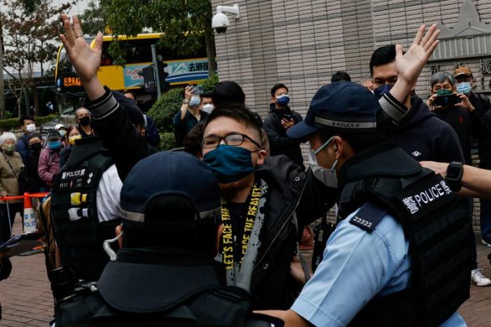 A supporter is taken away by police outside the West Kowloon Magistrates' Courts building during the hearing of the 47 pro-democracy activists charged with conspiracy to commit subversion under the national security law, in Hong Kong