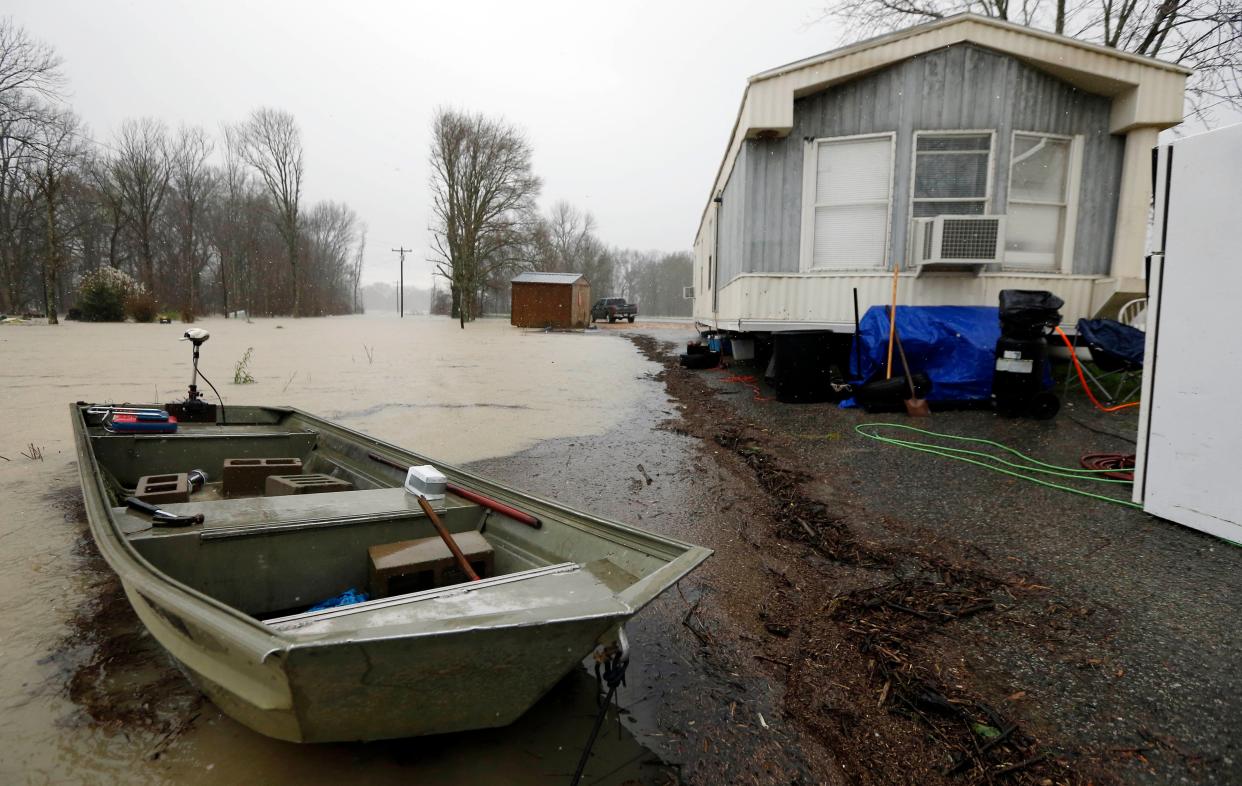 Backflow waters flood home property and farmland near Rolling Fork, Miss., in March 2019.